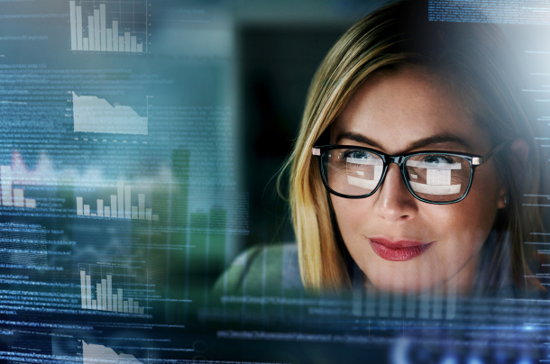 a woman looking at multiple analytics dashboards