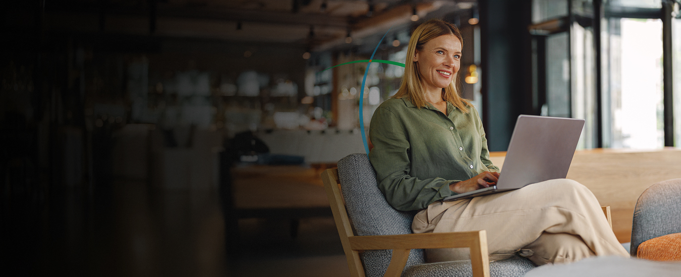 banner showing a smiling business professional working on her laptop