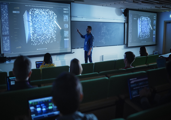 stock-photo-young-male-teacher-giving-a-data-science-lecture-to-diverse-multiethnic-group-of-female-and-male-2300906313 1