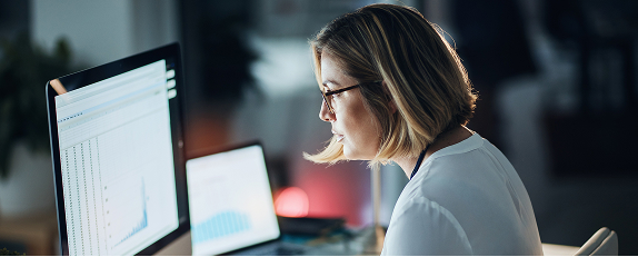 a woman looking at a computer screen displaying data-driven insights