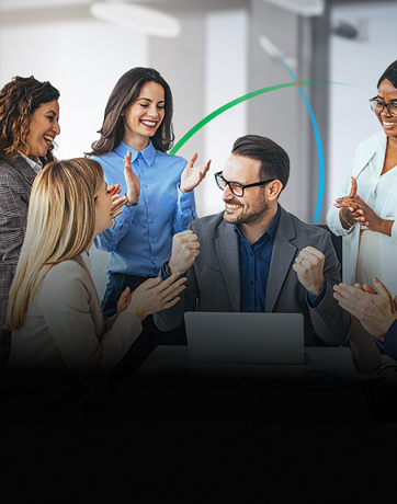 banner showing a team of business professionals celebrating success in a modern office space